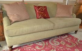 Lot 206: Haverty's celadon green two cushion sofa; 33"h x 78"w x 41"d; includes throw pillows
