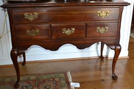 Lot 424: Q.A. style mahogany lowboy; 33"h x 42"w x 21"d, unknown maker, cabriole legs, brass pulls and scalloped apron
