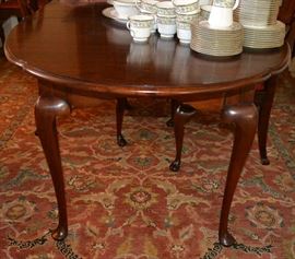 Lot 422:  Cherry Q.A. style dining table marked "Centennial, Watertown Table, Watertown WI" with three leaves; 30"h x 42"w x 76"l (with 1 leaf), each leaf 16"w 
