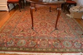Lot 425: Oriental style wool 8'x10' rug made in India, rust ground with taupe and green accents
