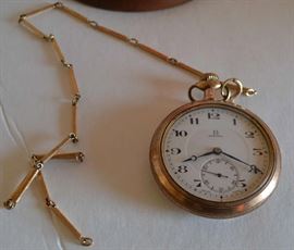 Lot 439: Gold plated Omega pocket watch in dome display case with chain, 17 jewels, #3656889 on movement, case #1565471.  Provenance with watch reads "Pocket watch and chain belongs to T. Bernard Littlepage (1884-1939) father of Anne L. Mitchelle of Prospect Hill, NC (41b)
