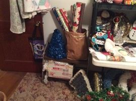 Quilts on door - all hand stitched, blue tinsel tree, Christmas paper in bulk, small wheeled cart