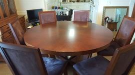 60" round table with 6 upholstered chairs in excellent condition.