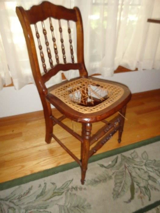 maple chair with wicker seat.. needs repair.. obviously