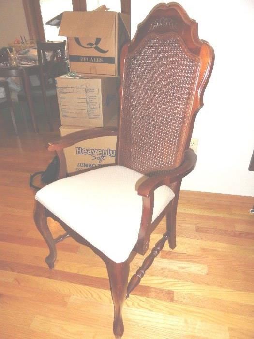 highland arm chair dark wood .. Sanger Furniture.. wicker back and upholstered seat