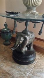 Very heavy elephant table with glass top.