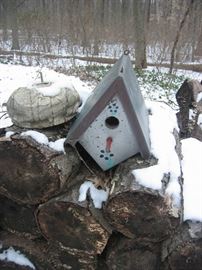 Several handmade bird houses with copper roofs