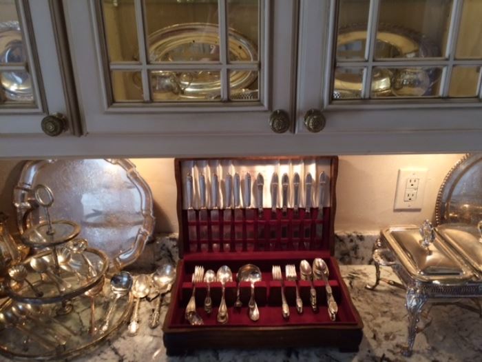 Flatware and lots of silver-plate serving pieces