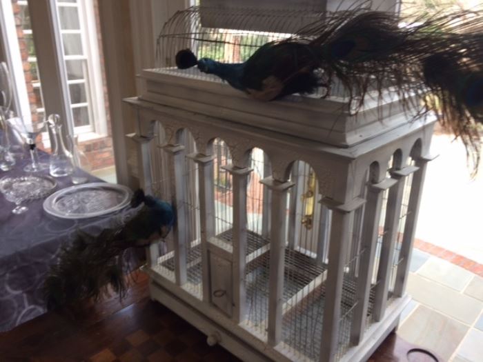 Large vintage wooden birdcage with ornamental peacocks
