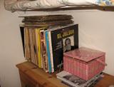 Vintage record albums and sewing box filled with vintage sewing items.