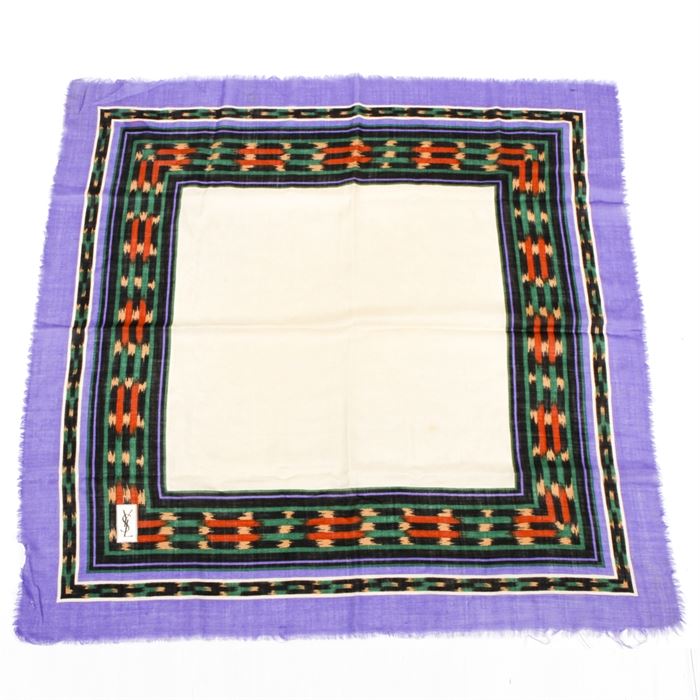 Yves Saint Laurent Wool Challis Scarf: A Yves Saint Laurent wool challis scarf. This scarf features a cream central square with multiple borders in black, green, cream, orange, and periwinkle. Tagged YSL in the lower left corner. Measures 34″ × 34″.