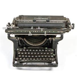 Antique Underwood Typewriter: An antique Underwood typewriter. The black typewriter has all of its buttons, levers, and pulls. The typewriter is missing a front panel that sits above the buttons.