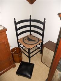 Unusual black corner chair with woven seat
