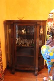 beautiful curio with some vintage Cambridge and Fostoria glass.  Also, one Lladro buy with cymbals.