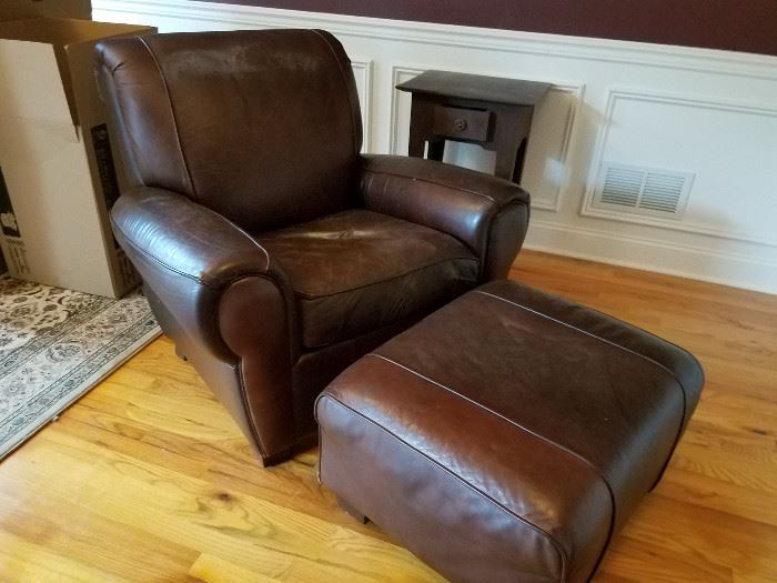 Brown leather chair and ottoman, one of a pair