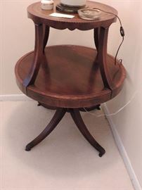 1940's tier table table with leather top tier with gold inlay around the rim and Duncan Phyfe style legs