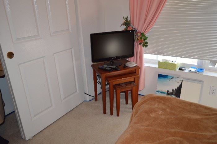 Flatscreen TV, nesting tables, single bed, clothes