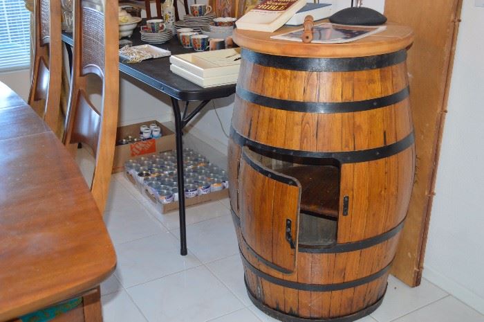 Wine barrel holds wine and glasses