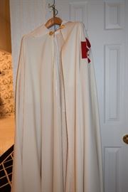 Cape/Robe from The Equestrian Order of the Holy Sepulchre.The Equestrian Order of the Holy Sepulchre of Jerusalem (EOHSJ) is a nine-hundred-year-old organization with a mission of critical need today: to help preserve Christianity in the Holy Land. It is a lay order under the protection of the Holy See with members worldwide who actively support the Latin Patriarch (the Archbishop of Jerusalem) with prayers, donations and a presence through pilgrimages. Practicing Catholics who actively support their diocese and parish may be nominated to be members of the Order.