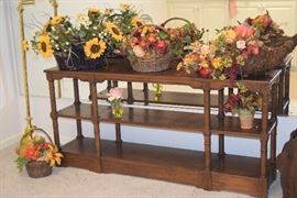 Three tiered sofa table and floral arrangements