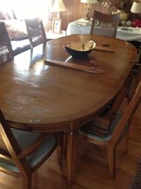 Cool midcentury diningroom table with 6 chairs. Chairs have cane back 