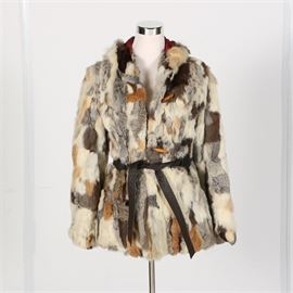Mixed Rabbit Fur Hooded Jacket: A mixed rabbit fur hooded jacket. This car length jacket features dyed and natural mixed rabbit in a white, gray, browns and golden hued pelts. The fully lined wrap style jacket features a wood toggle and loop closure at the bodice and a black leather waist belt. Labeled Made in Korea, size M.