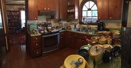 To the left and through the "Red Room" or "Library" you will find the kitchen. Lots of practical use pottery, kitchen items, the vintage bread box and the Luna Garcia dinner and salad plates.