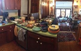 To the left and through the "Red Room" or "Library" you will find the kitchen. Lots of practical use pottery, kitchen items, the vintage bread box and the Luna Garcia dinner and salad plates.