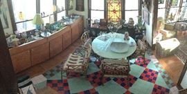 Past the library and kitchen is the "dining room" or sun room. Practical pottery, Art Deco French prints, Chinese Chippendale chairs and lots of art is in this room. 