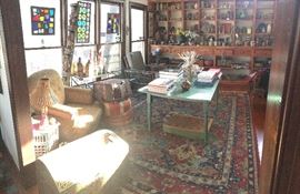 This is the "studio". To get here from the front door, walk to the right as you come in (but not up the stairs). This room has the Thai doors, the stained glass, the more expensive books, some very nice chairs, the poufs, the Matthew Williamson "Vishnu, Vishnu" piece and lots of pottery. 