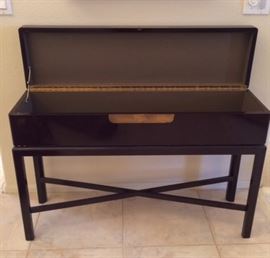 Lacquered storage console with flip-top opened up for storage