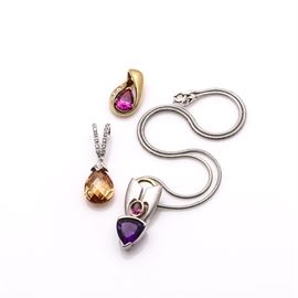 Sterling Silver Neck Chain and Slides: A sterling silver neck chain and slides. This item features a spring ring closure attached to a snake chain. One of the three slides has a pear shaped peach colored cubic zirconia. Another slide is gold tone with three cubic zirconias and a synthetic ruby. The final slide has gold tone accents and a rhodolite garnet and trillion cut amethyst. The total approximate weight inclusive of all non-metal materials is 0.89 ozt.