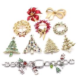 Collection of Holiday Brooches: A collection of holiday brooches. This item features a Christmas-themed watch charm bracelet and nine brooches. These include a bow, a poinsettia bloom, three wreaths, and four Christmas trees.