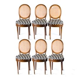 Henri Bonjour Cane Chairs with Cushions: A set of six Henri Bonjour chairs made in France. These wooden chairs have a chestnut stained finish and feature round caned seats and backs; each chair also has a black and white striped seat cushion tied on at the stiles. These chairs are marked “Ameublements Henri Bonjour & Cie.; 29-42-44, Cours de la Liberté; Teleph. Vaudrey 11-60 Lyon.”
