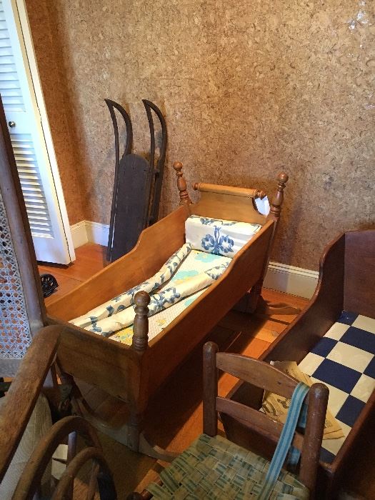 several antique cribs and cradles