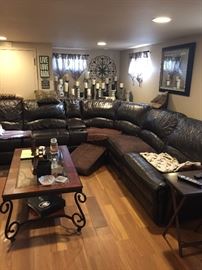 leather sectional sofa 11' x 11' with 2 recliners at each end and coffee table, artwork, candlesticks, mirrors