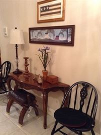 Entry table, vintage chairs, and the great camel saddle.