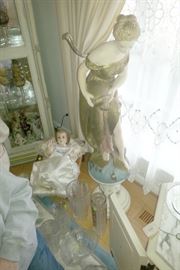 Life size baby Jesus in manger statue. Greek woman pouring statue