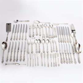 Wallace Sterling Silver "Rose Point" Place Settings for 12 and Serving Pieces: A collection of Wallace Sterling flatware and serving pieces. In the “Rose Point” pattern, this set includes twelve each of dinner forks, salad forks, strawberry forks, cocktail forks, teaspoons, soup spoons, iced tea spoons, table knives, steak knives, and flat handle butter spreaders. There are three demitasse spoons. Includes one each of jelly server, salad spoon, serving table spoon, ice cream scoop, pie server, spatula, serving fork, two-tine olive fork, and ice scoop. Total approximate weight is 18.266 ozt, excluding knives, spatula, pie server, and two scoops (ice scoop has a silver plate bowl).