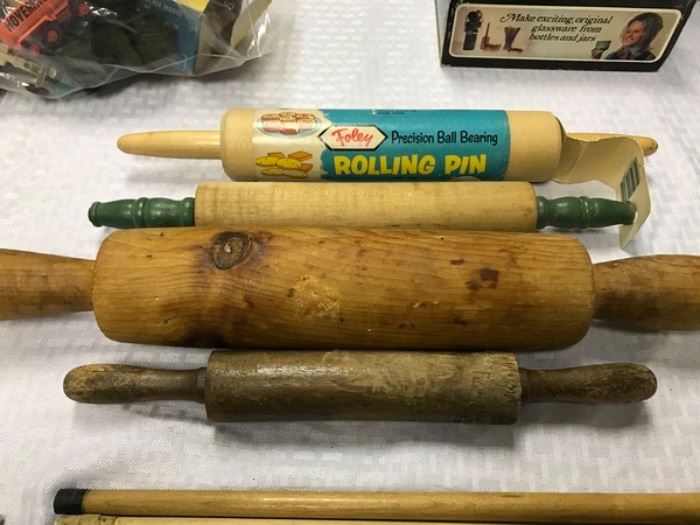 4 vintage rolling pins - one with green handles, one with original Foley paper still intact, 2 appear to be hand made/carved.