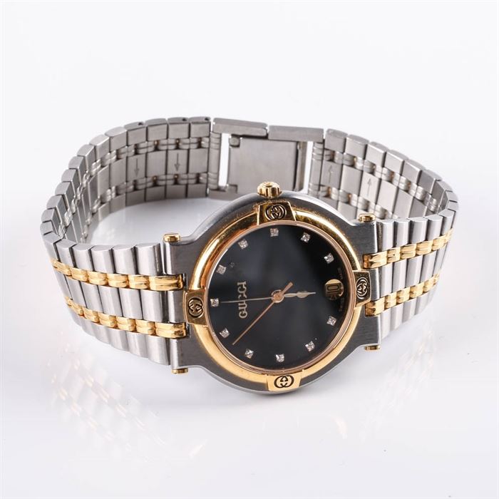 Women's Gucci Stainless Steel and Gold Plated Wristwatch: A women’s gold plated and stainless steel wristwatch with crystal accents by Gucci.