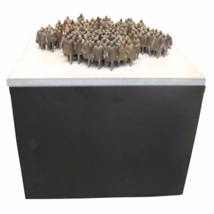 William Hodd McElcheran "8:45 A.M." Bronze Sculpture: A solid bronze sculpture titled 8:45 A.M. by Canadian designer and sculptor, William Hodd McElcheran (1927–1999). McElcheran is best known for crafting a variety of large and small figural sculptures, often military related. This sculpture features a total of fourteen various sized bronze pieces ranging from single figures to large clusters of figures that are mounted into the stone top via screws to the underside of each piece. The grey stone top then rests on a large wooden pedestal with a black finish.