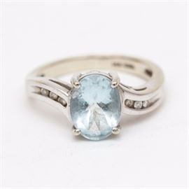 EMA 14K White Gold Aquamarine and Diamond Ring: A white gold ring with oval faceted aquamarine to the center of an offset shank with round cut diamonds to the shoulders.