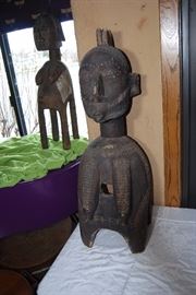 This impressive and superb wooden shoulder mask comes from the Baga people.  This is a classical example that displays many traditional components such as the spherical head, the plaited hair with medial crest, a large noses and pendulous breasts which hang close to the body,  its four legs, and geometric patterns decorating the hairstyle and the breast . This mask depicts a bust of a woman on four legs. Such mask is known as a D'mba headdress, that is by far the most well known Baga work of art. Its use was documented as early as 1886.  It represents an older woman who has given selflessly, and also represents community. It is worn on the head with a costume of raffia and cloth.

The Nimba masks, often monumental works carried on the shoulders, rank among the largest of all ritual objects in West Africa. Their use, as hinted at above, is rather ubiquitous. They are used at funerals, harvest festivals, and at initiations. Normally these "masks" have four legs or posts (for placement on