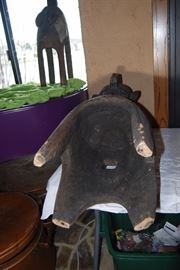 This impressive and superb wooden shoulder mask comes from the Baga people.  This is a classical example that displays many traditional components such as the spherical head, the plaited hair with medial crest, a large noses and pendulous breasts which hang close to the body,  its four legs, and geometric patterns decorating the hairstyle and the breast . This mask depicts a bust of a woman on four legs. Such mask is known as a D'mba headdress, that is by far the most well known Baga work of art. Its use was documented as early as 1886.  It represents an older woman who has given selflessly, and also represents community. It is worn on the head with a costume of raffia and cloth.

The Nimba masks, often monumental works carried on the shoulders, rank among the largest of all ritual objects in West Africa. Their use, as hinted at above, is rather ubiquitous. They are used at funerals, harvest festivals, and at initiations. Normally these "masks" have four legs or posts (for placement on