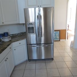 Maytag Stainless steel Refrigerator freezer with double doors and bottom freezer and digital controls.  Nice.