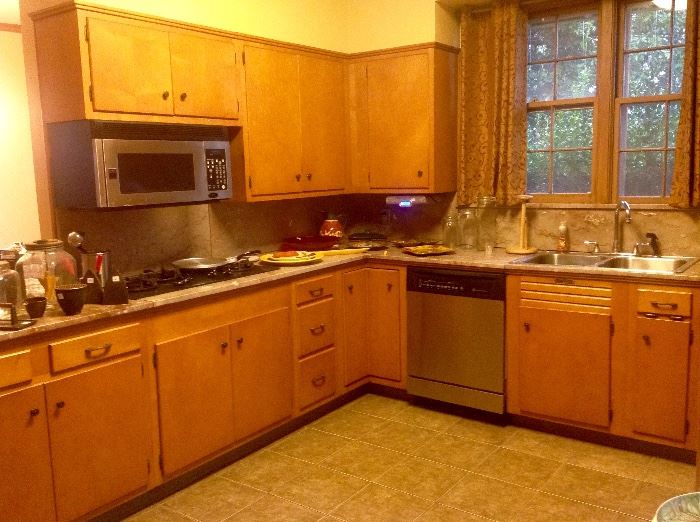 Another view of cabinetry, stainless microwave and dishwasher 