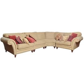 Robin Bruce Four Piece Sectional Sofa: A Robin Bruce sectional sofa. This four-piece sectional features tweed upholstery throughout and a nailhead trim on the rolled arm panels and front seat rails. Includes a variety of throw pillows.