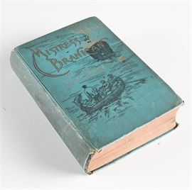 1891 First American Edition of "Mistress Branican" by Jules Verne: A first American edition of Mistress Branican by Jules Verne. Published in 1891 by Cassell Publishing Company, this hardcover features black and white illustrations. The book is bound in blue cloth and features gilt script on the spine and cover.