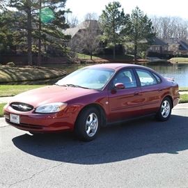 2002 Ford Taurus 4S: A 2002 red Ford Taurus 4S sedan with 3.0L V6 automatic transmission with overdrive, VIN 1FAFP55S42A103342; odometer reads 40333. This mid-size 4-door sedan features a grey cloth interior, power locks, windows and doors, power driver’s seat, AC, AM/FM radio, rear defogger, and intermittent wipers.